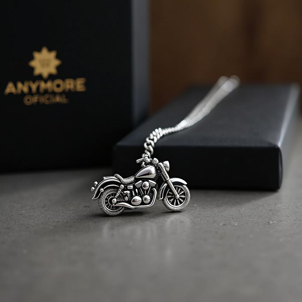 A silver motorcycle pendant necklace elegantly displayed on a table