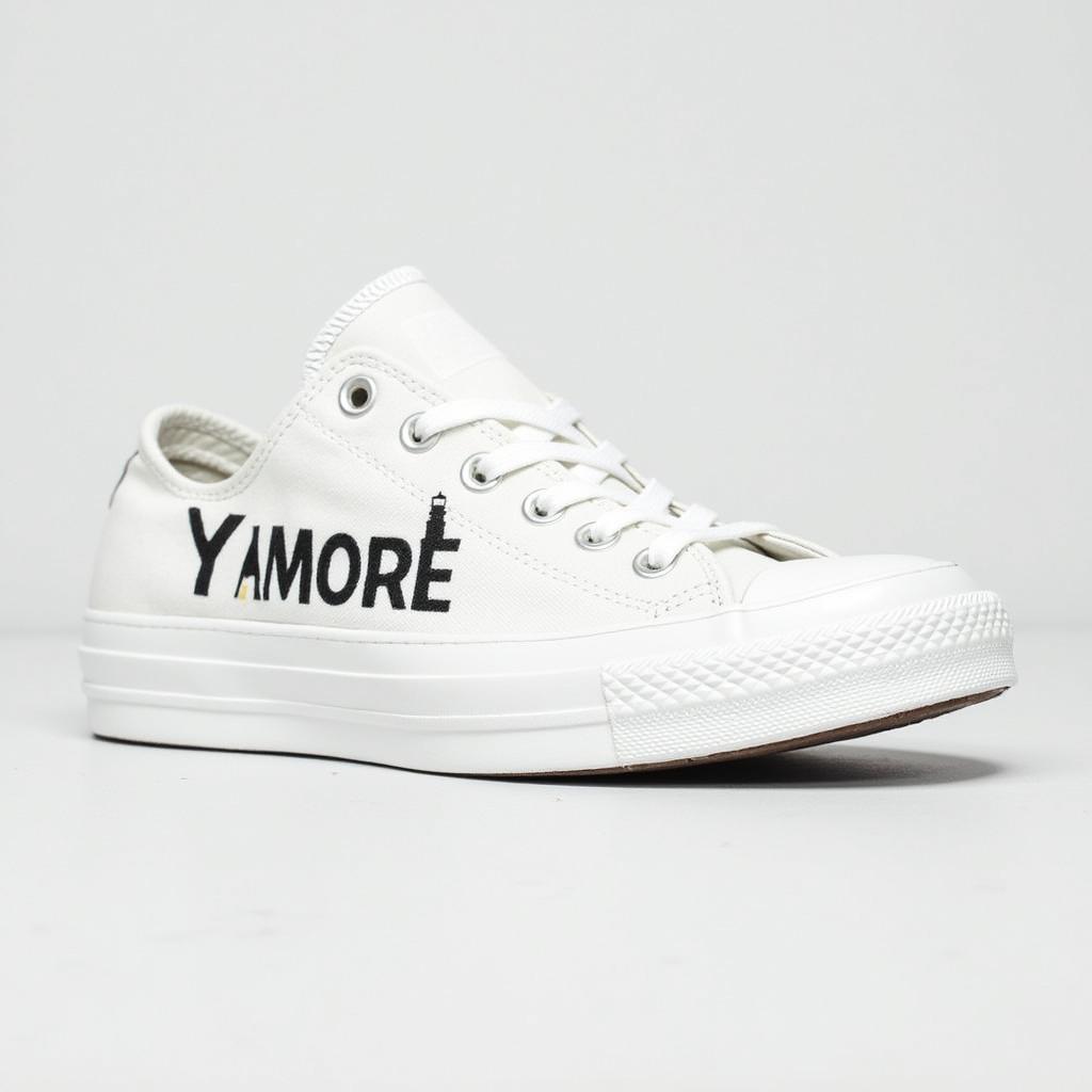 White sneakers in the style of All Star, featuring the word 'ANYMORE' on the side