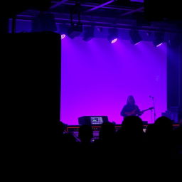 A vibrant scene with a purple-lit background, featuring striking silhouettes of large speakers and a detailed sound engineer's console