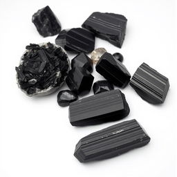 A striking assortment of Black Tourmaline crystals, featuring both raw and polished forms, displayed on a pure white backdrop