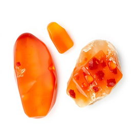 Carnelian crystals in both polished and raw forms displayed gracefully on a bright white backdrop