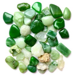 A pile of different Jade crystals, featuring both polished and raw forms, beautifully displayed on a pristine white backdrop