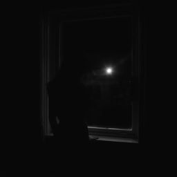 a woman approaching a window and gazing outside at night, captured in a dark, black and white image