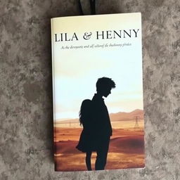 A captivating book cover featuring the silhouettes of two characters, Lila and Henry