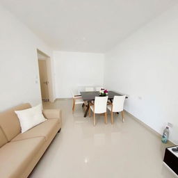 A minimalist and modern living room, featuring a beige sofa with a white pillow, a dining table with six white-cushioned chairs, and a bouquet of flowers