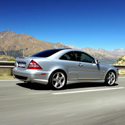 A 2005 Mercedes-Benz C220 Sport Coupe depicted in an engaging action shot as it drives along a winding mountain road