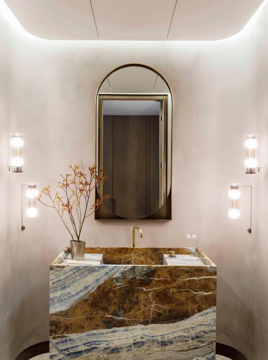 An elegant bathroom featuring a stylish stone sink with a rich brown texture