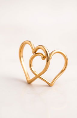 A pair of intertwined gold rings shaped like hearts, showcasing intricate detailing and a polished finish