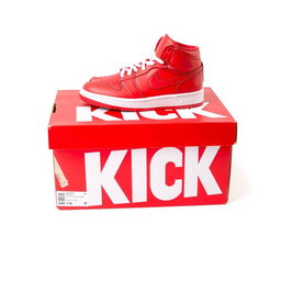 A full view of a bright red shoebox featuring bold white letters spelling 'KICK' on the side