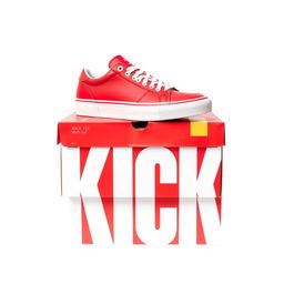 A full view of a vibrant red shoebox featuring bold white letters spelling 'KICK' on the side