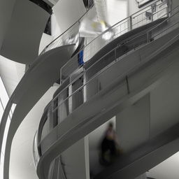 A spiral staircase with an operator standing on it.