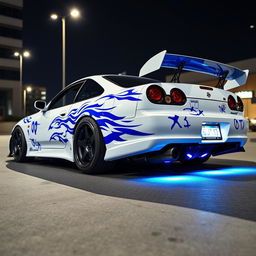 A pristine white Nissan Silvia S14 Kouki with striking blue tribal decals wrapped around the body