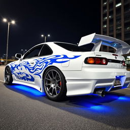 A pristine white Nissan Silvia S14 Kouki with striking blue tribal decals wrapped around the body