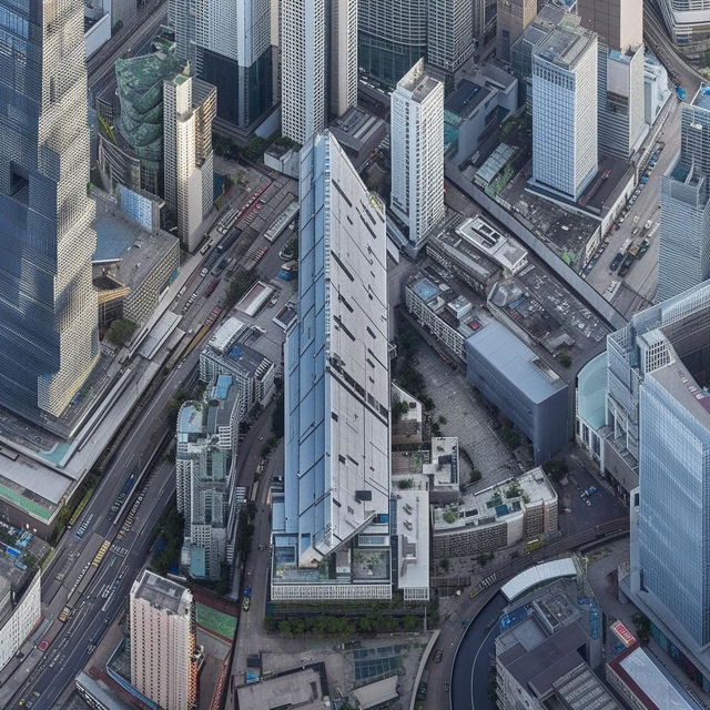 A daytime aerial view of a SWAT premises located in the heart of a bustling central business district, awash with the activity of the surrounding skyscrapers and busy streets.