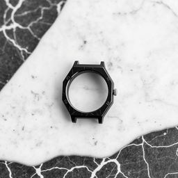 A watch casing made of striking black marble, showcasing its smooth finish and rich texture