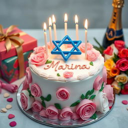 A beautifully decorated birthday cake featuring elegant pink and white roses, a prominent blue Magen David symbol made of icing, and topped with burning candles