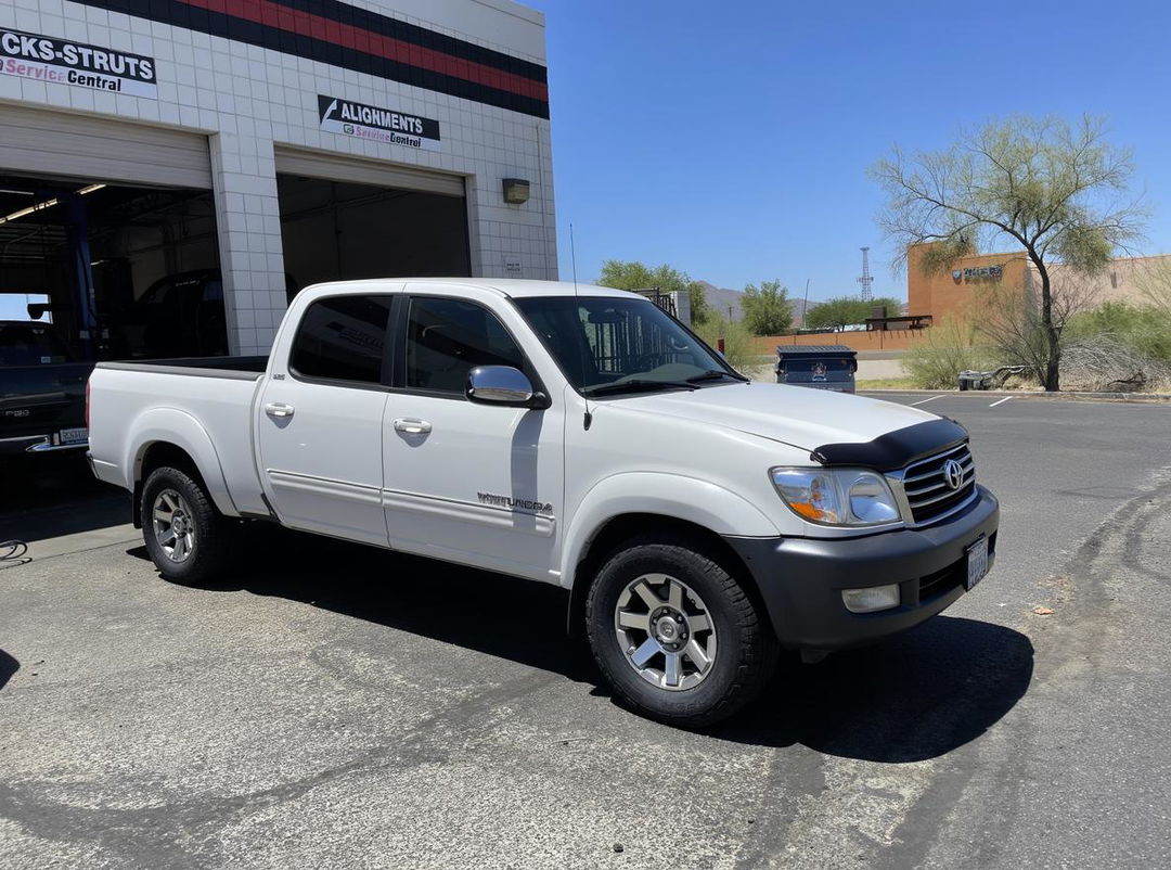 A white 2002-2003 Toyota Land Cruiser 100 transformed into a pickup truck