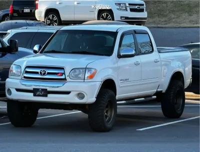 A modified white Toyota pickup truck with a lifted suspension, seamlessly transformed to feature the front design of a Toyota Land Cruiser 100