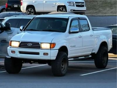 A front view of a 2003 Toyota Land Cruiser 100 pickup truck, capturing its powerful presence and distinctive features