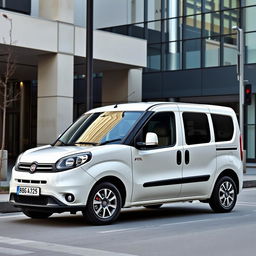 A striking Fiat Doblo vehicle in a pristine white finish, situated in an urban environment