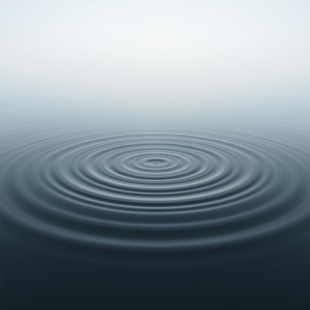 A photorealistic image of concentric ripples spreading across a calm body of water, under a soft, hazy, blue-grey sky