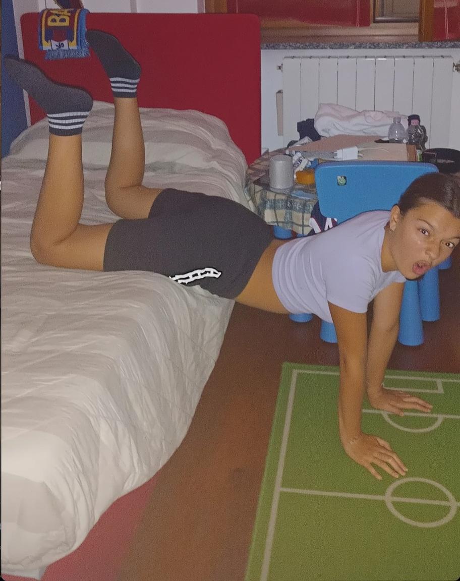 A playful indoor scene with a person in a light bedroom setting