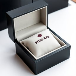 A luxurious black watch box featuring a rich burgundy logo elegantly embossed with the name 'ROSE BEE'