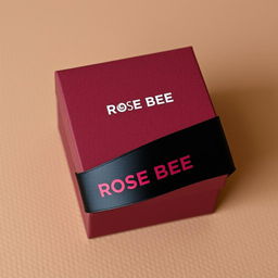 A maroon cartoon-style watch box prominently featuring a bold black text logo that reads 'ROSE BEE'