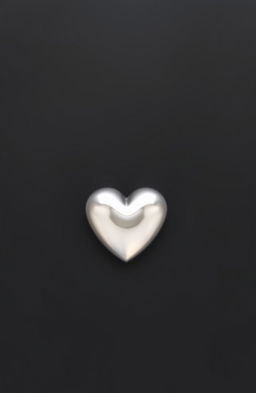 A solid black background with a shiny silver heart in the center