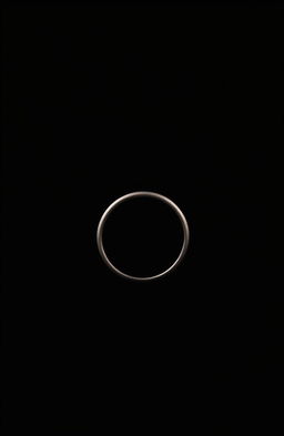 A simple ring positioned sideways, set against a mysterious black background