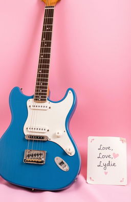 A vintage blue electric guitar elegantly positioned against a soft pink background, accompanied by a handwritten letter that reads "Love, Lydie