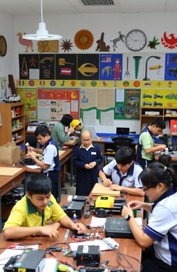 A vibrant classroom scene depicting students engaged in Technical and Vocational Education and Training (TVET) in Malaysia