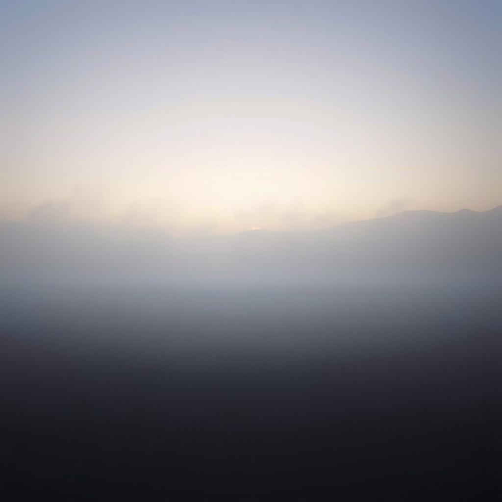 A tranquil and atmospheric scene depicting a misty plain at dawn