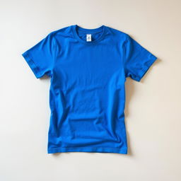 A vibrant blue t-shirt displayed prominently on a soft, neutral background