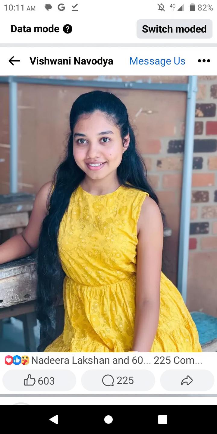 A portrait of a young woman with long, flowing black hair, wearing a vibrant yellow dress