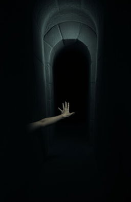 A long stone crypt situated in a dimly lit room