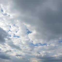 An expansive view of a cloudy sky filled with varying shades of gray and white clouds, some fluffy and others more textured, creating a dynamic and dramatic atmosphere