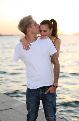 A young man, around 24 years old, stands on a waterfront, wearing jeans and a white t-shirt
