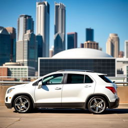 A lowered white 2012 Chevy Trax parked in a modern urban environment