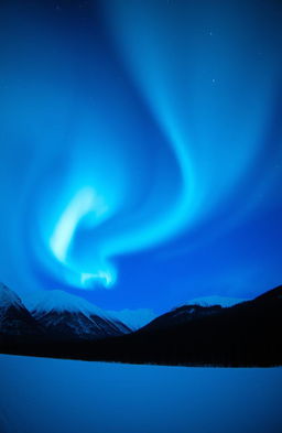 A stunning aurora borealis display in vibrant shades of blue, swirling and dancing across the night sky