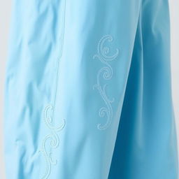 A pair of long pants in a sky blue color, featuring elegant wave embroidery along the seams