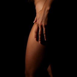 An alluring and intimate scene where a man's hand gently rests on a woman's thigh, set in a dark and atmospheric environment
