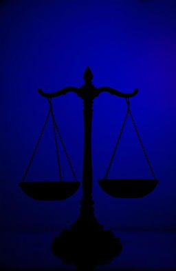 A striking silhouette of the scales of justice, symbolizing fairness and balance