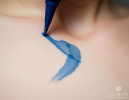 A close-up view showcasing blue ink from a ballpoint pen gradually fading and blurring across the skin
