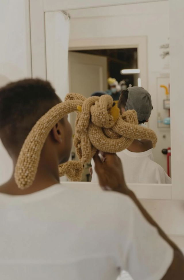 A person using a toothbrush in front of a mirror, showcasing the act of brushing their teeth