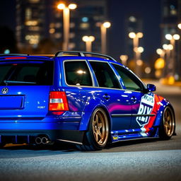A striking blue 2001 widebody VW Passat R36 wagon, configured as a drift car with a bold race livery, is parked at night