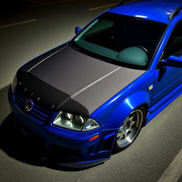 A blue 2001 widebody VW Passat R36 L wagon drift car with a carbon hood and aggressive aerodynamic features, parked at night