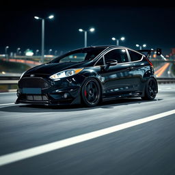 A sleek black Ford Fiesta ST in a time attack style, featuring an extreme wide bodykit and a large rear spoiler, parked on a highway at night