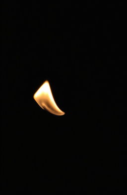 A delicate and fragile flame flickering gently against a dark background, casting soft shadows and a warm glow