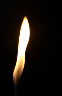 A delicate and fragile flame flickering gently against a dark background, casting soft shadows and a warm glow